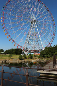 Low angle view of ferris wheel against sky