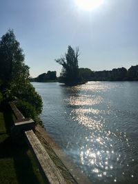 Scenic view of river against sky on sunny day