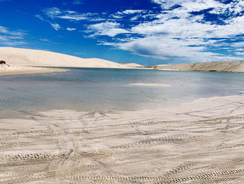 Blue raining water in white sand dunes 