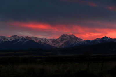 Scenic view of snowcapped mountains against sky during sunset