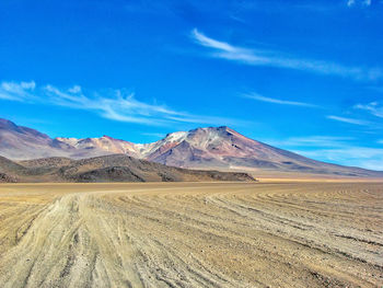 Scenic view of arid landscape against sky