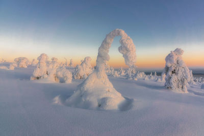 Panoramic view of snow covered land against sky