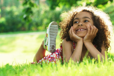 Portrait of young woman sitting on grass