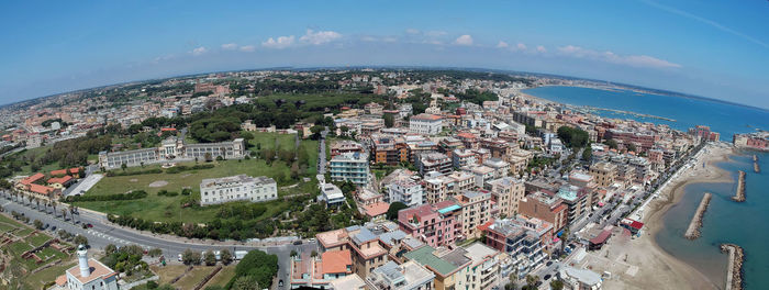 High angle view of townscape by sea against sky