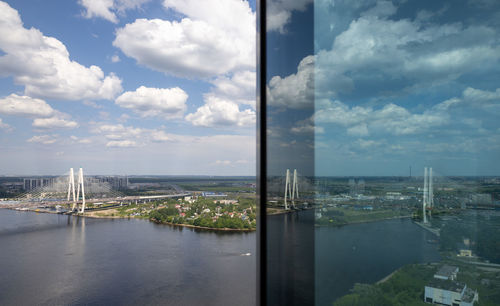 City at waterfront against cloudy sky