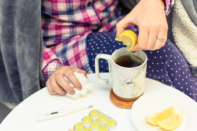 Woman drinking hot tea on a sick day.