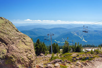 Scenic view of mountains against blue sky