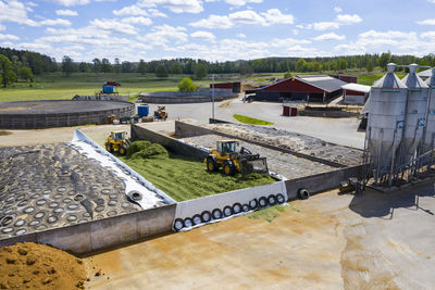 High angle view of swimming pool by lake against sky