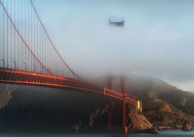 Golden gate bridge in the clouds early in the morning just after sunrise