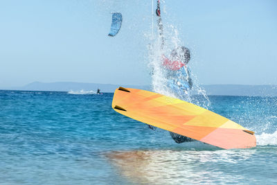 Man kiteboarding on sea