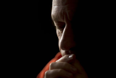 Close-up of human hand against black background