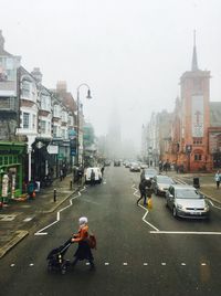 People on city street against sky