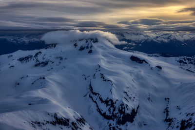 Scenic view of snow covered mountains against sky during sunset