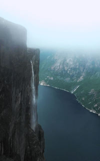 Scenic view of waterfall against sky