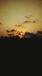 Scenic view of silhouette field against sky during sunset
