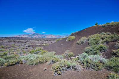 Scenic view of land against clear blue sky