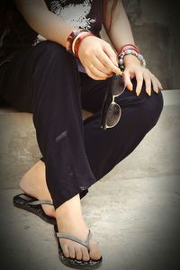 Low section of woman sitting on floor