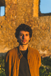 Portrait of young man with autumn leaves