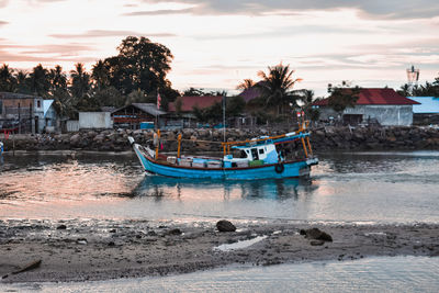 Boats in marina at sunset