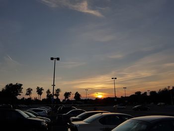 Traffic on road at sunset