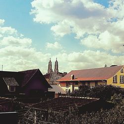 Houses in town against sky