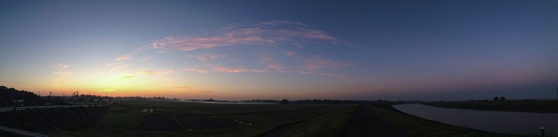 Scenic view of field against sky at sunset