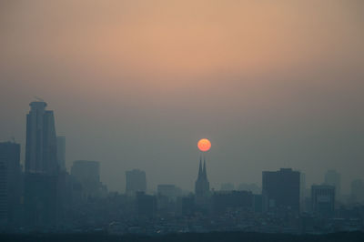 Low angle view of city at sunset