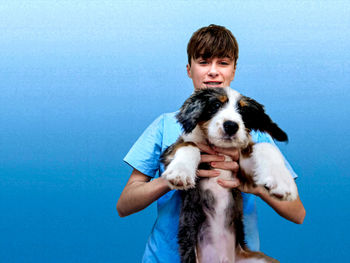 Close-up of dog against blue background