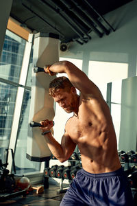 Rear view of man exercising in gym