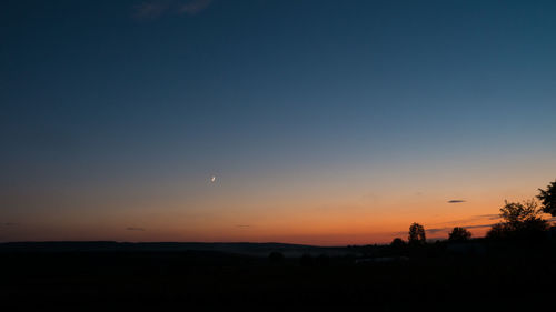 Scenic view of silhouette landscape against sky during sunset