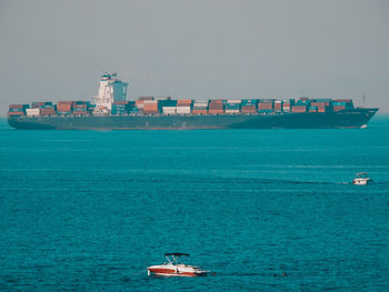 Boat sailing in sea against sky