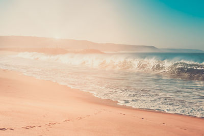 Scenic view of beach against sky during sunset