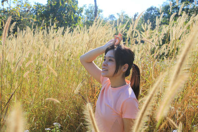 Smiling woman standing in farm