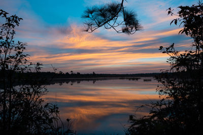 Scenic view of lake against romantic sky at sunset