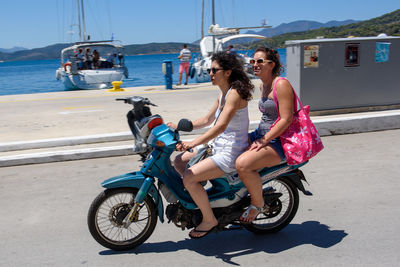 Woman riding bicycle on sea shore