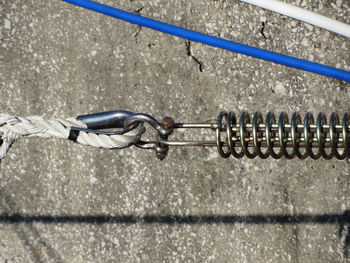Close-up of rope hanging on metal