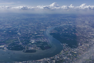 Aerial view of cityscape and mountains against sky