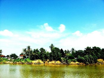 Scenic view of calm lake against cloudy sky