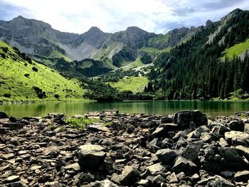 Scenic view of lake and mountains against sky