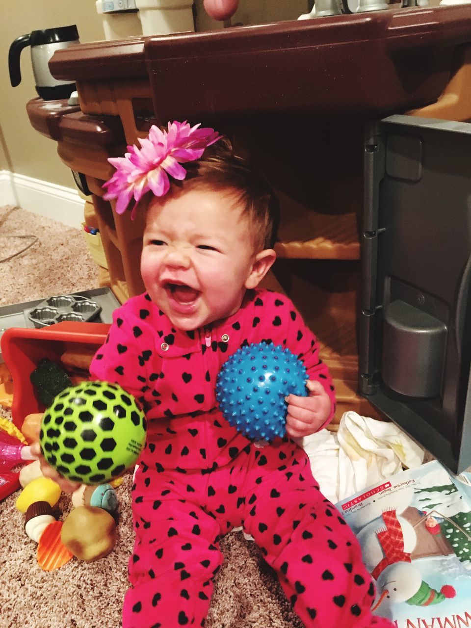 child, childhood, one person, real people, holding, lifestyles, cute, front view, innocence, girls, indoors, happiness, leisure activity, portrait, smiling, home interior, toy, mouth open