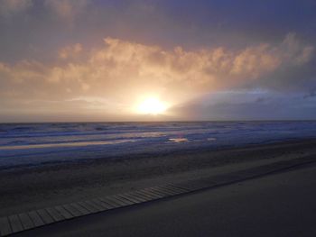 Scenic view of beach against sky during sunset