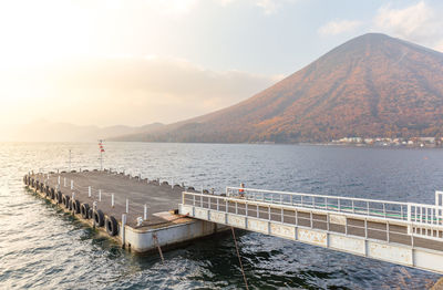 Scenic view of sea and mountains against sky