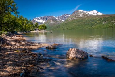 Scenic view of gjevilvatnet lake in oppdal, norway and mountains against sky