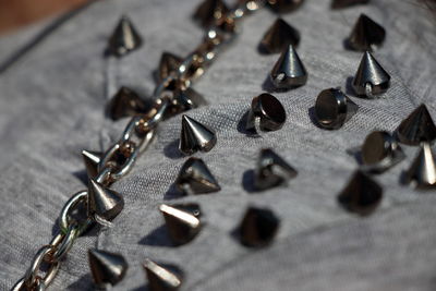 Close-up of metal spikes on gray fabric