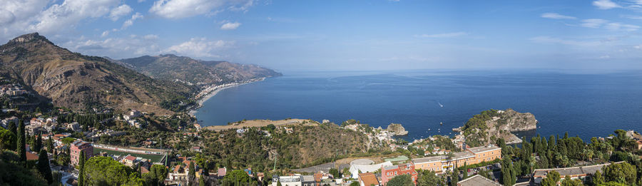 Aerial wide angle view of taormina and its beautiful coastline