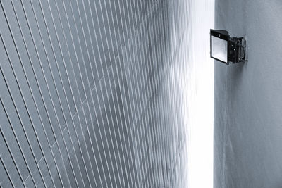 Low angle view of electric lamp on wall