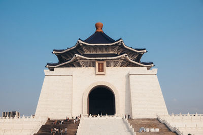 Low angle view of building against clear blue sky