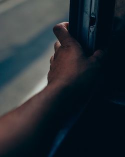 Cropped hand of person on window