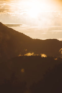 Scenic view of silhouette mountains against sky during sunset