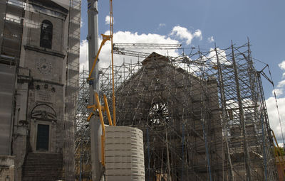 Low angle view of building under construction against sky